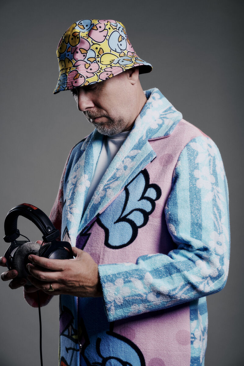 Sebastien Bruce in a long colourful coat with headphones