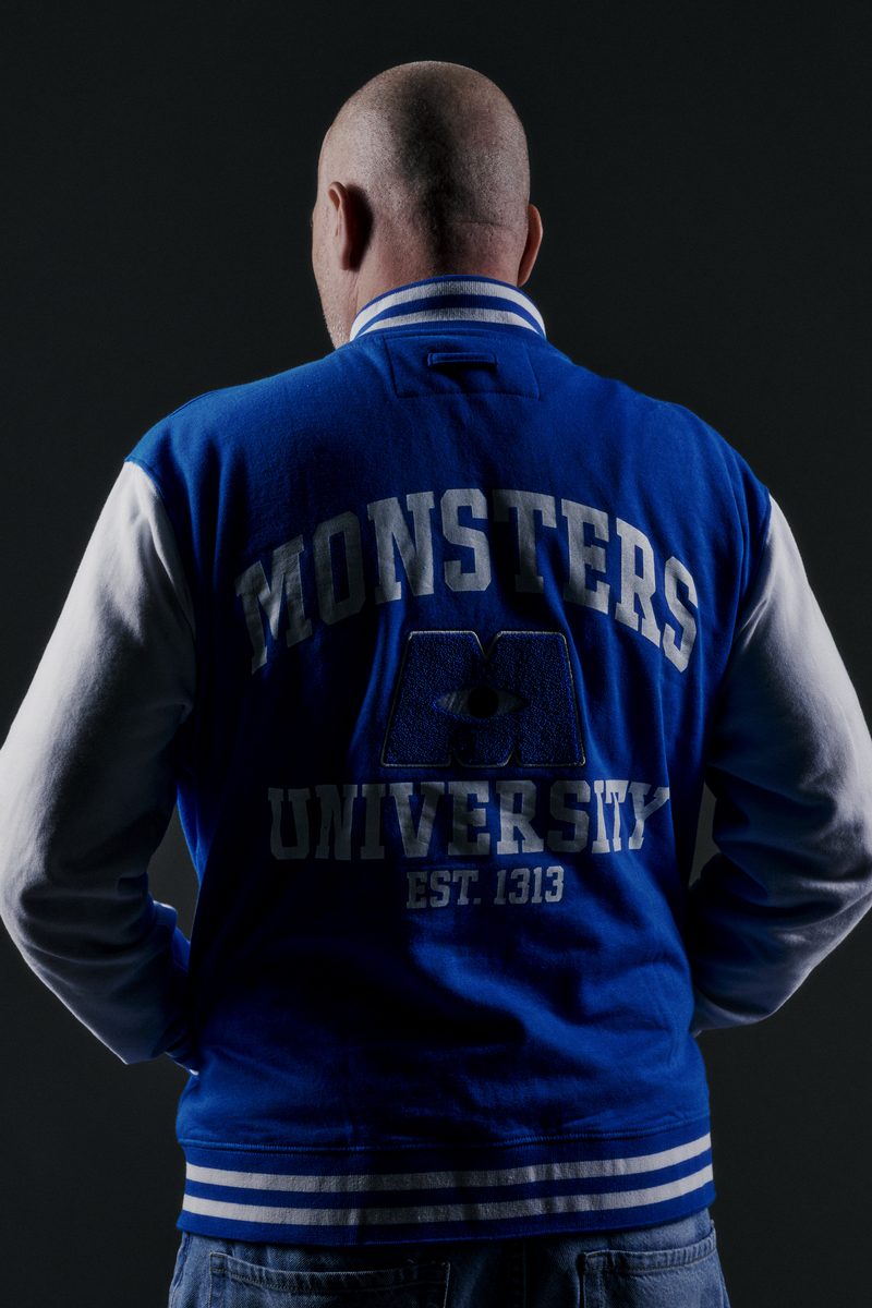 Sebastien Bruce from behind in a blue varsity jacket